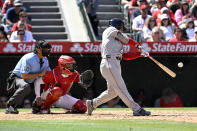 Boston Red Sox's Masataka Yoshida, right, hits an RBI single next to Los Angeles Angels catcher Logan O'Hoppe and umpire Phil Cuzzi (10) during the sixth inning of a baseball game in Anaheim, Calif., Sunday, April 7, 2024. (AP Photo/Alex Gallardo)