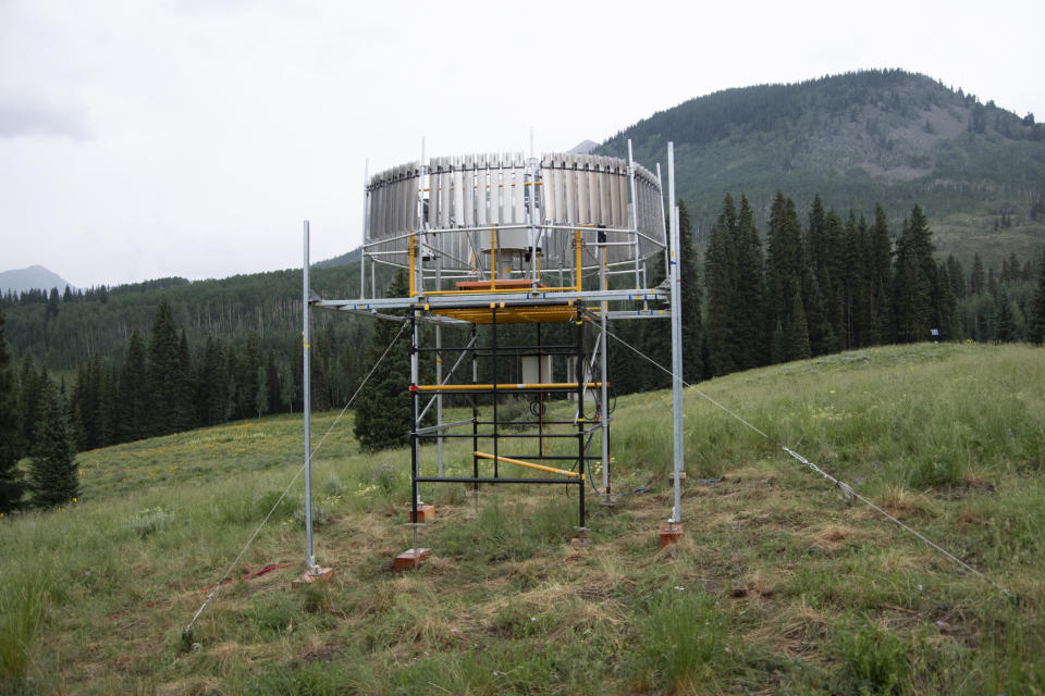 This July 14, 2021 photo provided by Lawrence Berkeley National Laboratory shows a rain gauge that will measure the amount of liquid precipitation that falls during the Atmospheric Radiation Measurement (ARM) user facility's Surface Atmosphere Integrated Field Laboratory (SAIL) field campaign in Gothic, Colo. Measurements from the rain gauge will also help scientists validate precipitation estimates from radar. (John Bilberry/Lawrence Berkeley National Laboratory via AP)