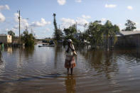 Maria Dorsaint wipes sweat from her face on the way to her church, Haitian United Evangelical Mission, which was damaged by flooding from Hurricane Irma in Immokalee, Florida, U.S. September 12, 2017 REUTERS/Stephen Yang