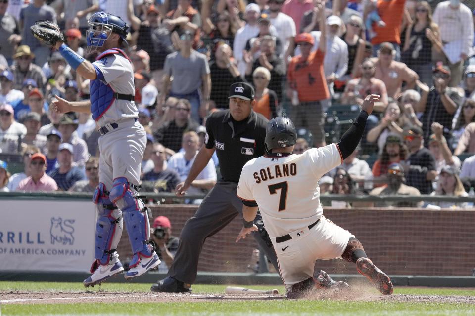 San Francisco Giants' Donovan Solano, right, slides into home plate past Los Angeles Dodgers catcher Austin Barnes, left, to score a run on a double by LaMonte Wade Jr. during the seventh inning of a baseball game Thursday, July 29, 2021, in San Francisco. (AP Photo/Tony Avelar)