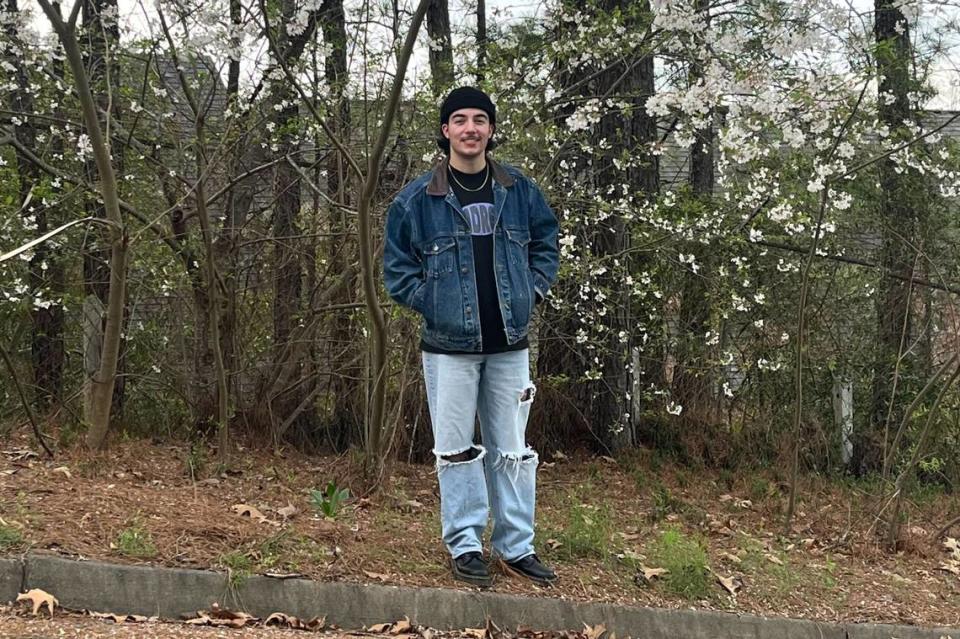 Jesse Fraga, breaking news reporter for The Macon Telegraph, poses in front of a flower tree in Macon, Ga. on March 24, 2024, when temperatures hit 42 F – cold for the native Floridian.