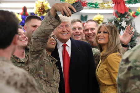 U.S. President Donald Trump and First Lady Melania Trump greet military personnel at the dining facility during an unannounced visit to Al Asad Air Base, Iraq December 26, 2018. REUTERS/Jonathan Ernst