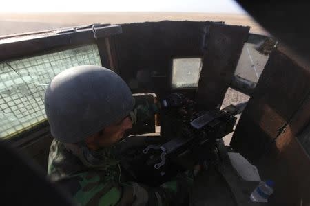 A member of the Kurdish Peshmerga forces takes his position in a military vehicle on the southeast of Mosul , Iraq, August 14, 2016. REUTERS/Azad Lashkari