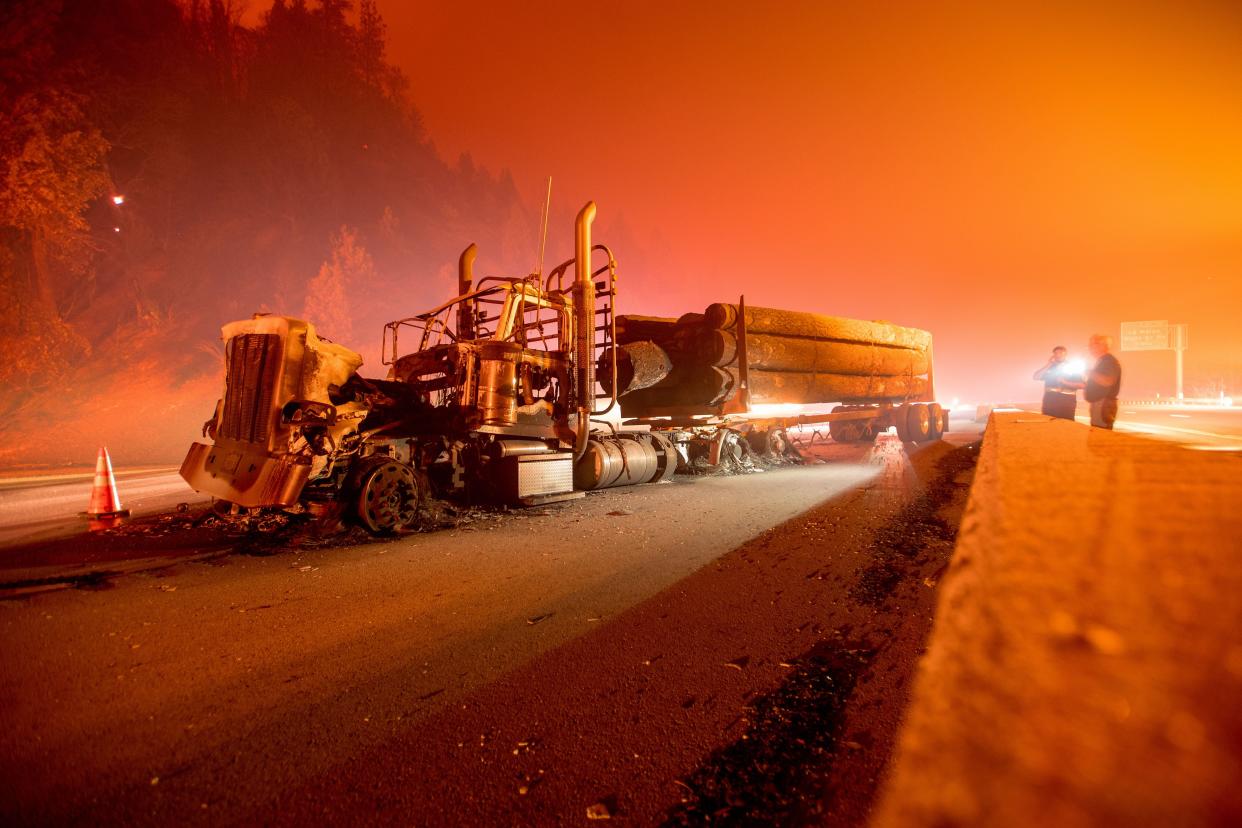 An abandoned smoldering truck after the Delta Fire tore through the area north of Redding, California and jumped the interstate on 5 September 2018 (AFP via Getty Images)