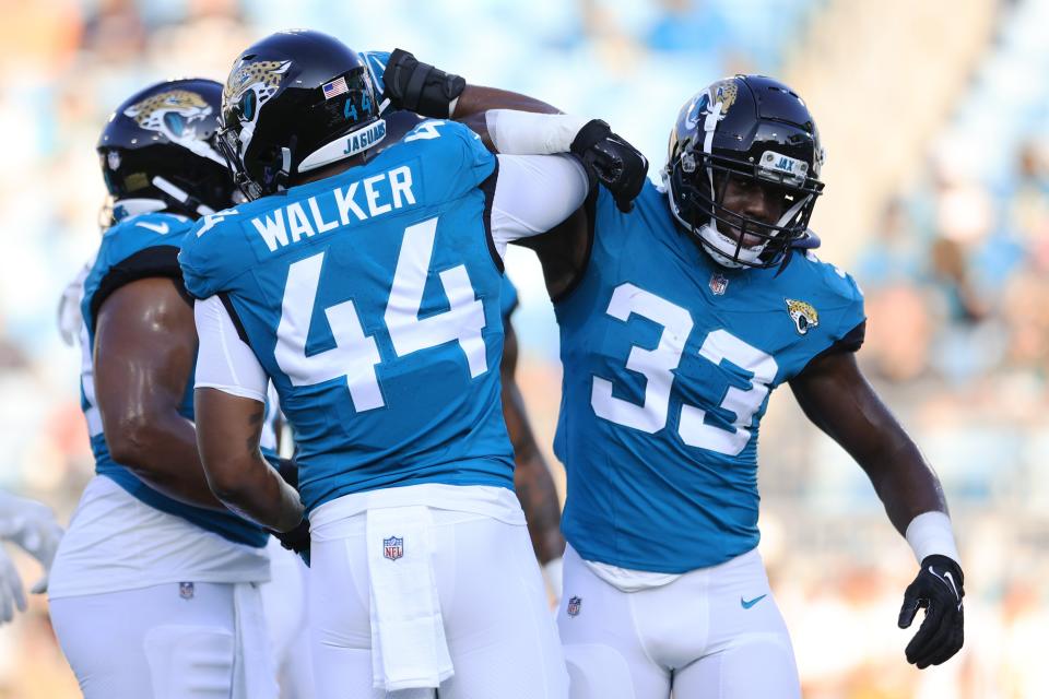 Jacksonville Jaguars linebacker Travon Walker (44) greets linebacker Devin Lloyd (33) before the game of a preseason matchup Saturday, Aug. 26, 2023 at EverBank Stadium in Jacksonville, Fla. [Corey Perrine/Florida Times-Union]