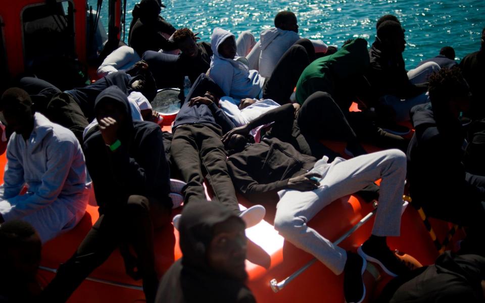 Migrants rescued by the Spanish coastguard wait to be transferred in Tarifa - AFP