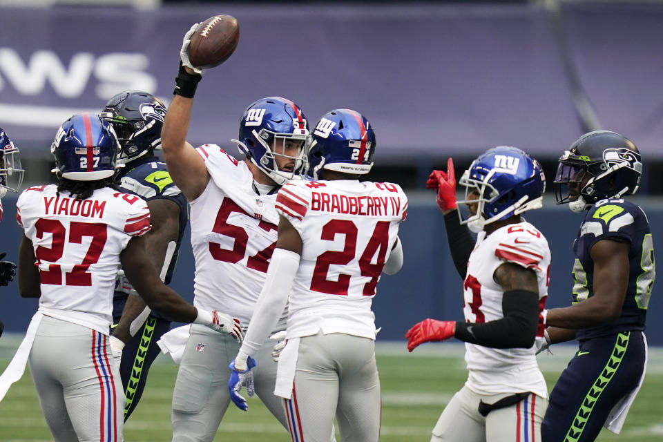 New York Giants defensive end Niko Lalos (57) celebrates with teammates after he recovered a fumble by Seattle Seahawks quarterback Russell Wilson (not shown) during the first half of an NFL football game, Sunday, Dec. 6, 2020, in Seattle. (AP Photo/Elaine Thompson)