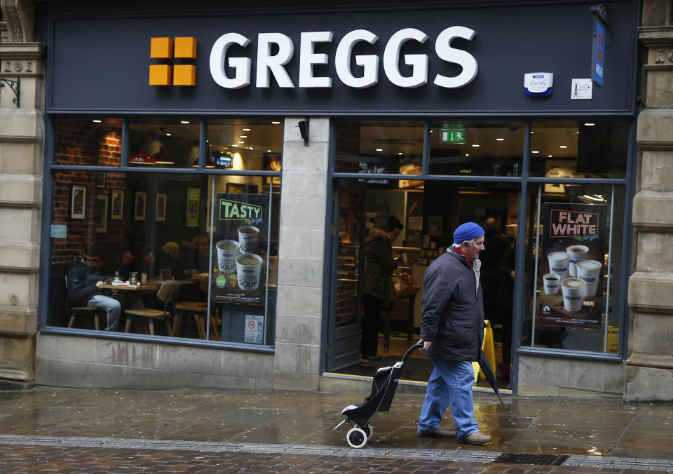 A man walks past a Greggs bakery in Bradford, Britain March 1, 2016. Greggs plans to close three bakeries and cut up to 355 jobs as part of a 100-million-pound ($140 million) restructuring programme, the British baker announced on Tuesday.  REUTERS/Phil Noble