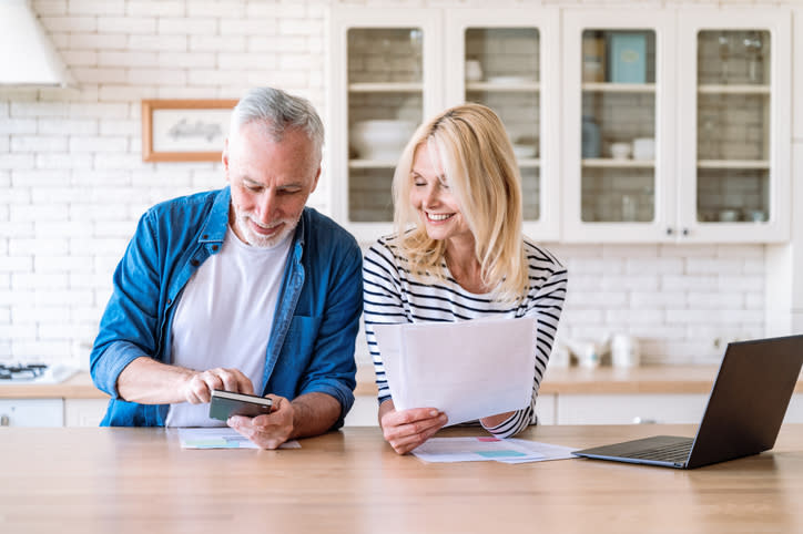 A senior couple reviews their retirement plan.