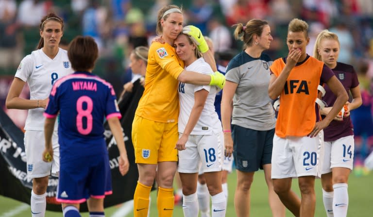 England players leave the pitch after their last-second 2-1 loss to Japan in a FIFA Women's World Cup semi-final in Edmonton, Canada on July 1, 2015