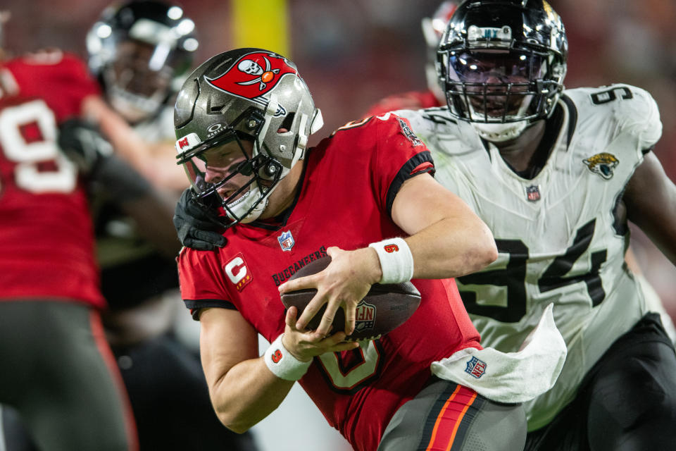 Dec 24, 2023; Tampa, Florida, USA; Jacksonville Jaguars defensive lineman Folorunso Fatukasi (94) sacks Tampa Bay Buccaneers quarterback Baker Mayfield (6) in the fourth quarter at Raymond James Stadium. Mandatory Credit: Jeremy Reper-USA TODAY Sports