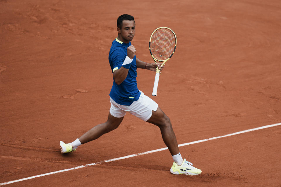 Bolivia's Hugo Dellien clenches his fist after scoring a point against Austria's Dominic Thiem during their first round match at the French Open tennis tournament in Roland Garros stadium in Paris, France, Sunday, May 22, 2022. (AP Photo/Thibault Camus)