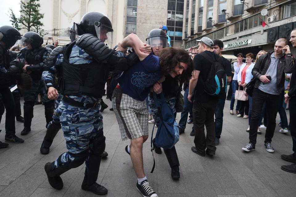 Russian police officers detain a participant of an opposition rally in Tverskaya street in central Moscow.