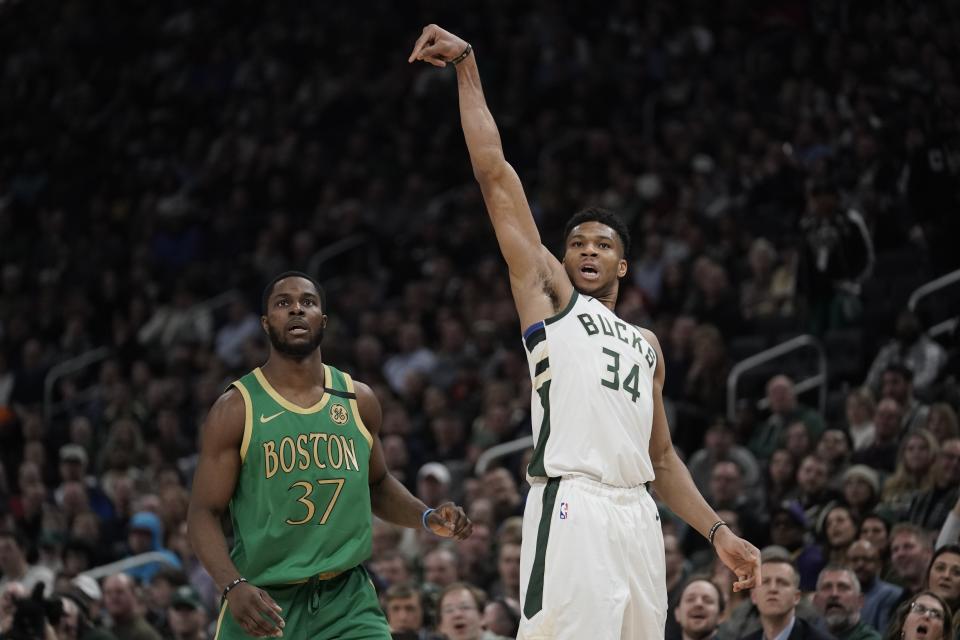 Milwaukee Bucks' Giannis Antetokounmpo shoots a three-point asket during the first half of an NBA basketball game against the Boston Celtics Thursday, Jan. 16, 2020, in Milwaukee. (AP Photo/Morry Gash)