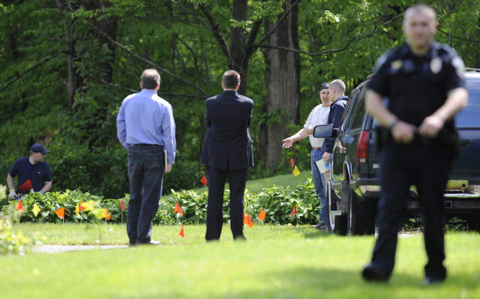 Law enforcement agents search the back yard of the home of reputed Connecticut mobster Robert Gentile in Manchester, Conn., Thursday, May 10, 2012. Gentile's lawyer A. Ryan McGuigan says the FBI warrant allows the use of ground-penetrating radar and believes they are looking for paintings stolen from Boston's Isabella Stewart Gardener Museum worth half a billion dollars. (AP Photo/Jessica Hill)