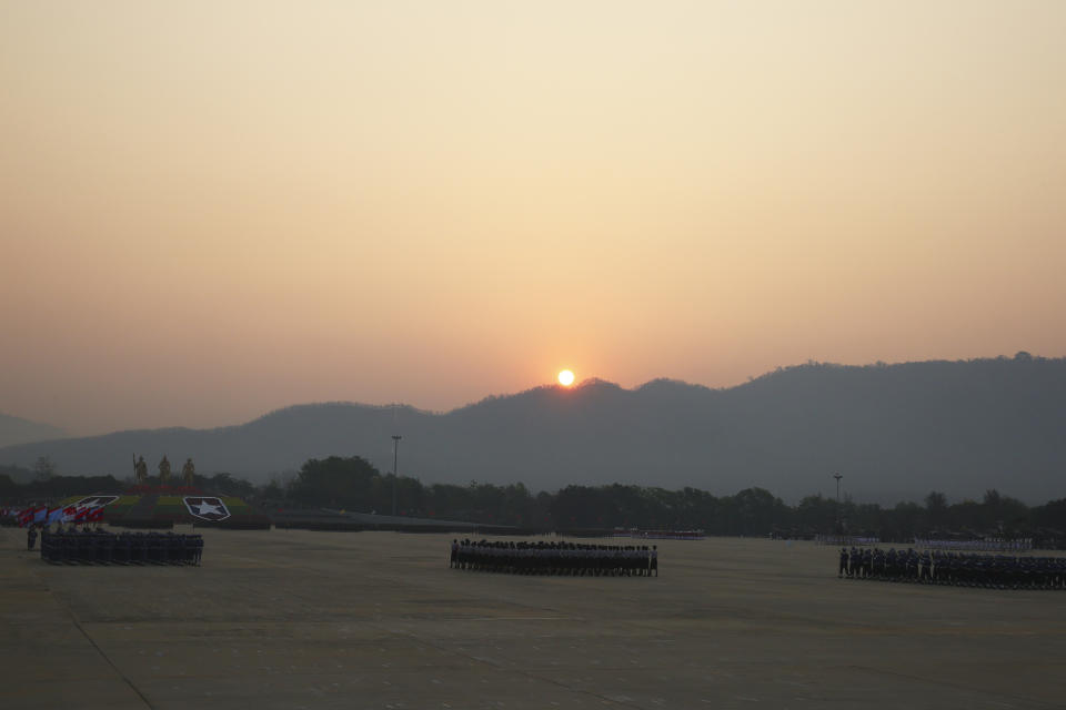 The sun rises as soldiers march ahead of a parade to commemorate Myanmar's 78th Armed Forces Day in Naypyitaw, Myanmar, Monday, March 27, 2023. (AP Photo/Aung Shine Oo)