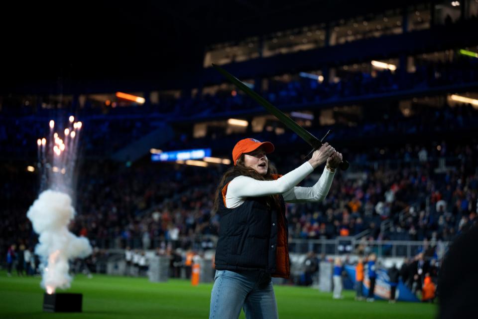 Rose Lavelle, United States National team member, pulls the sword from the stone before the MLS Eastern Conference semifinal match at Paycor Stadium in Cincinnati on Saturday, Nov. 25, 2023. FC Cincinnati defeated Philadelphia Union 1-0.