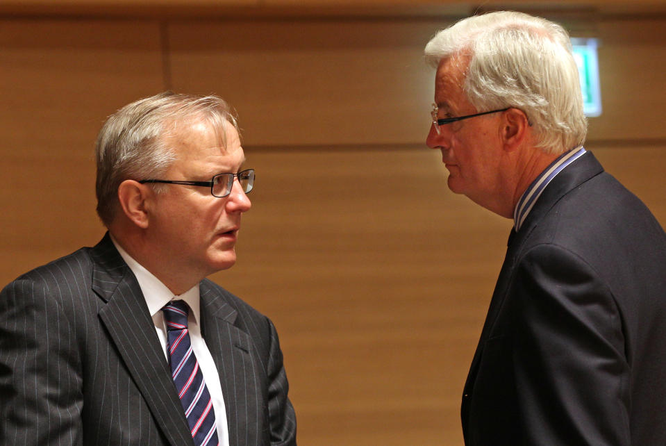 European Commissioner for Economic and Monetary Affairs Olli Rehn, left, talks with European Commissioner for Internal Market and Services Michel Barnier, at the EU finance ministers meeting, in Luxembourg, Tuesday Oct. 9, 2012. EU finance ministers assess the budgetary situation in Portugal and address the challenges of the European financial crisis. (AP Photo/Yves Logghe)