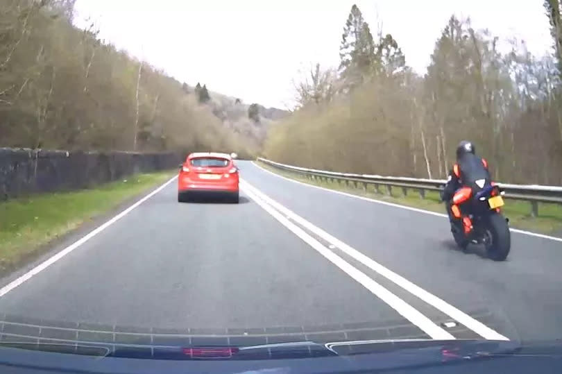 Biker chose wrong car to overtake on A470