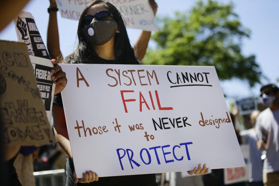 Protesters gather outside of the Queens County Criminal Court Monday, June 8, 2020, in the Queens borough of New York. As protesters of police brutality demand accountability, New York lawmakers are poised to overhaul a decades-old law, known by its section title, 50-a, that has kept officers' disciplinary records secret. (AP Photo/Frank Franklin II)