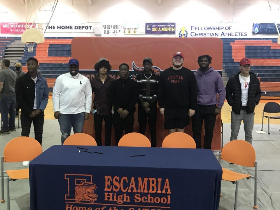 From left, Hershell Jefferson (Jamestown), Sam Allen (Tulsa), Lamont Sims (Campbellsville), Tai'shaun Key (Campbellsville), Rennie Prim Jr. (Campbellsville), Brennan Smith (Austin Peay), Tabari Taylor-Richardson (North Alabama) and Jaden Milliner (Arkansas State) sign at a ceremony at Escambia High School on Feb. 3, 2021.