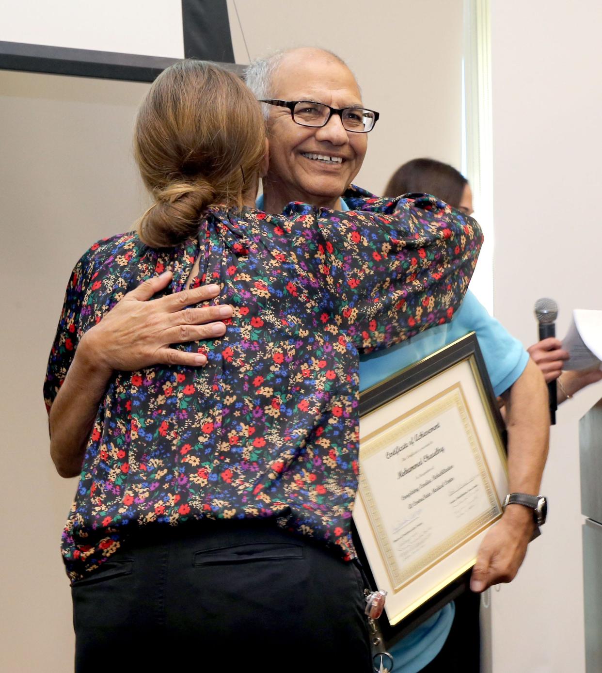 Jackson resident Mohammed Chaudhry receives a hug from a member of the cardiovascular team at CentraState Medical Center in Freehold on his "graduation day" August 31, 2023.