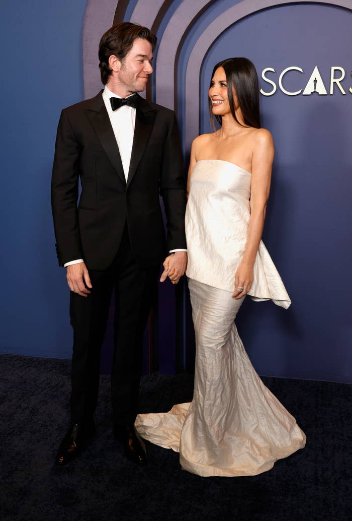 The two looking at each other and holding hands at the oscars