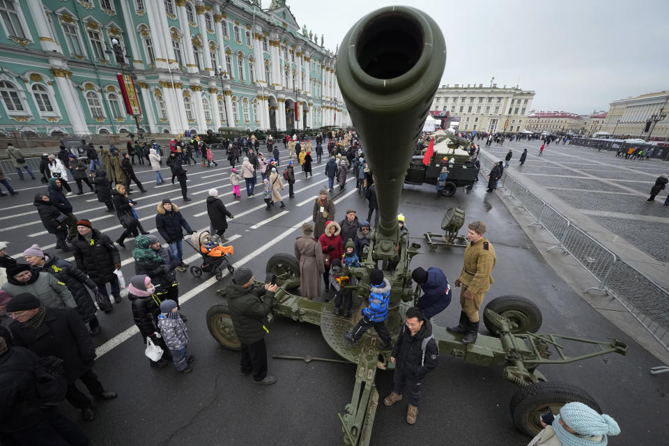 People visit a military-historical exhibition at the Dvortsovaya (Palace) Square, in St. Petersburg, Russia, Saturday, Jan. 27, 2024. The exhibition marked the 80th anniversary of the battle that lifted the Siege of Leningrad. The Nazi siege of Leningrad, now named St. Petersburg, was fully lifted by the Red Army on Jan. 27, 1944. More than 1 million people died mainly from starvation during the nearly900-day siege. (AP Photo/Dmitri Lovetsky)