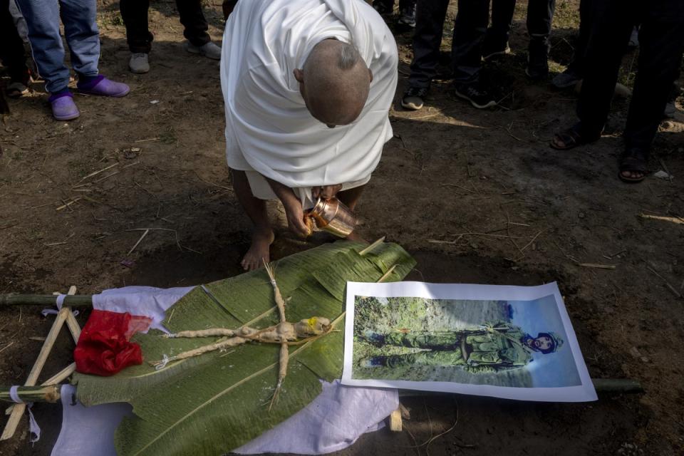 Gangadhar Paudel, an uncle of the deceased Hari Aryal, is dressed in white attire with a shaven head, as he starts Hari’s final rites procession in Walling, Syangja district, Nepal (EPA)