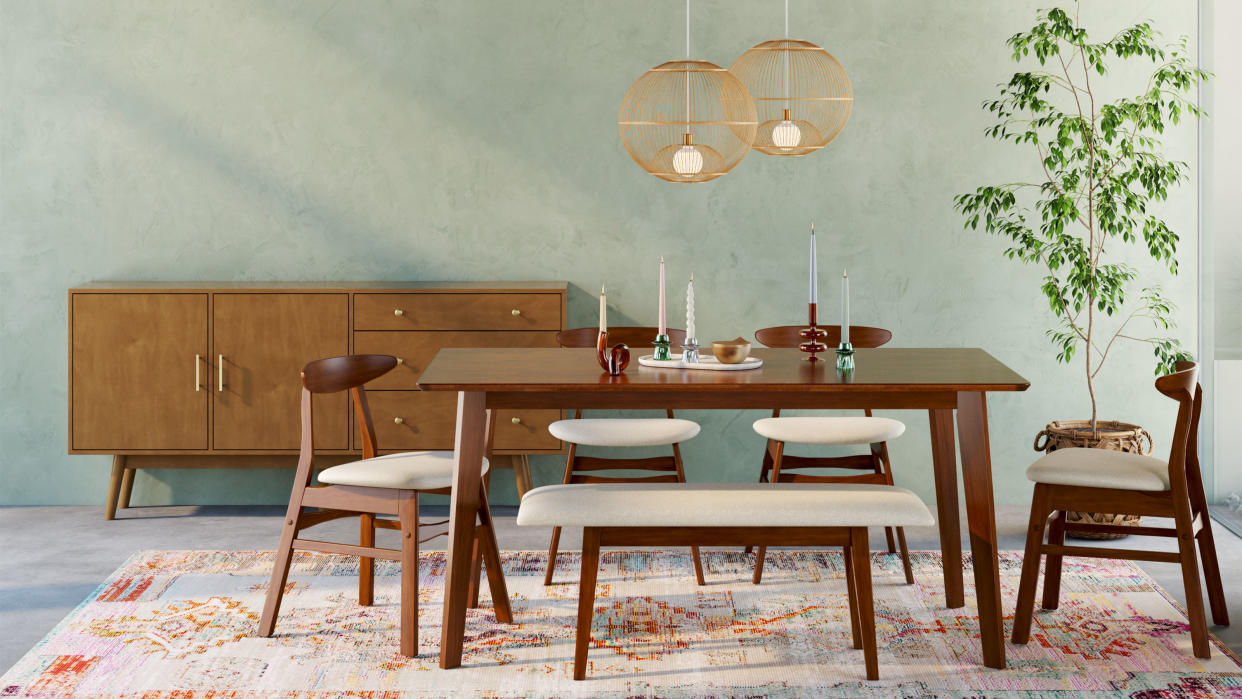  Walmart. Dark wooden dining table, matching chairs and bench, blue painted walls, rug, sideboard, pendants above table 