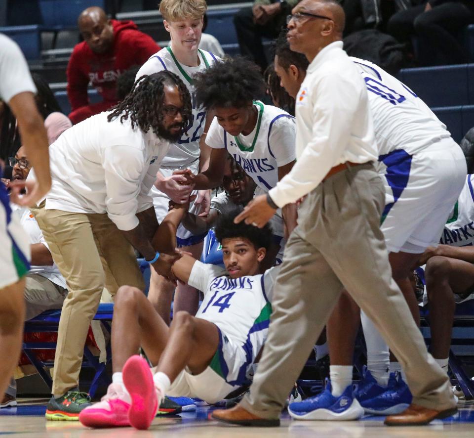 St. Georges' Blair Thomas is helped to his feet after crashing into his bench in the second half of Middletown's 60-40 win at St. Georges, Friday, Jan. 5, 2024.
