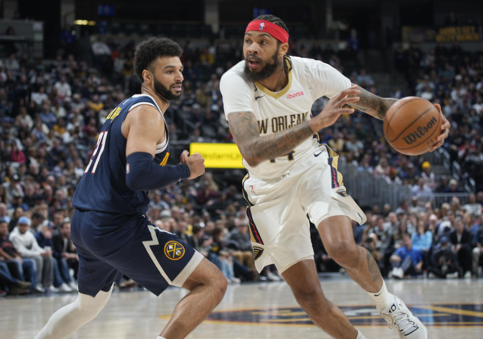 New Orleans Pelicans forward Brandon Ingram, right, drives to the rim past Denver Nuggets guard Jamal Murray in the second half of an NBA basketball game Tuesday, Jan. 31, 2023, in Denver. (AP Photo/David Zalubowski)