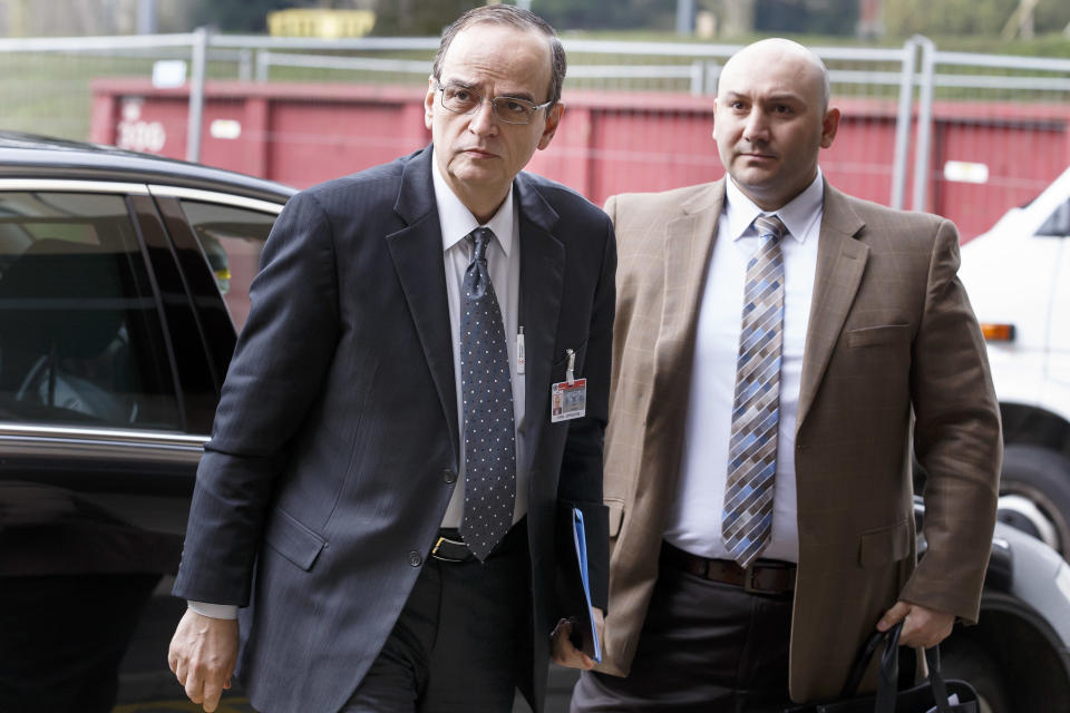 Syrian opposition chief negotiator Hadi Bahra, left, arrives for a meeting during the second round of negotiations between the Syrian government and the opposition at the European headquarters of the United Nations, in Geneva, Switzerland, Saturday, Feb. 15, 2014. U.N.-Arab League mediator Lakhdar Brahimi opened direct talks between the Syrian government and opposition Saturday in hopes of breaking the impasse in peace talks. Person at right is not identified. (AP Photo/Keystone, Salvatore Di Nolfi)