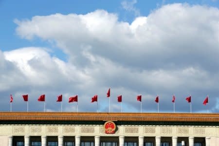 Red flags flutter on the top of the Great Hall of the People in Beijing, China September 30, 2018. REUTERS/Jason Lee