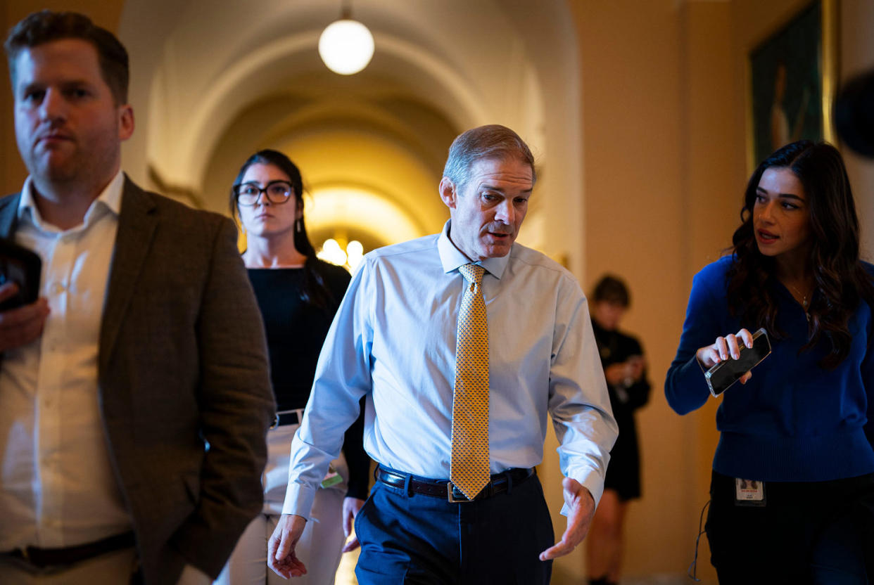 Rep. Jim Jordan walks through a hallway of the Capitol while being interviewed by a reporter (Al Drago / Bloomberg via Getty Images)