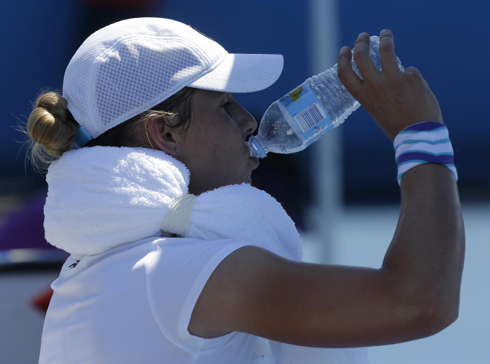 Marina Erakovic of New Zealand takes a drink during a break in her second round match against Zarina Diyas of Kazakhstan at the Australian Open tennis championship in Melbourne, Australia, Thursday, Jan. 16, 2014. (AP Photo/Mark Baker)