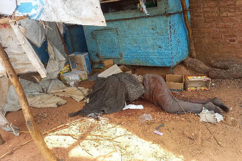 A picture taken on June 16, 2023, shows a covered body outside a house in the West Darfur state capital El Geneina, amid ongoing fighting between two generals in war-torn Sudan. / Credit: AFP via Getty Images