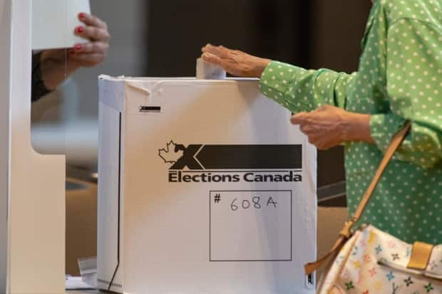 A voter casts her ballot at an advance polling station in Toronto on Sept. 10, 2021. Canadians are being told that voting will likely take longer than expected on Monday. (Evan Mitsui/CBC - image credit)