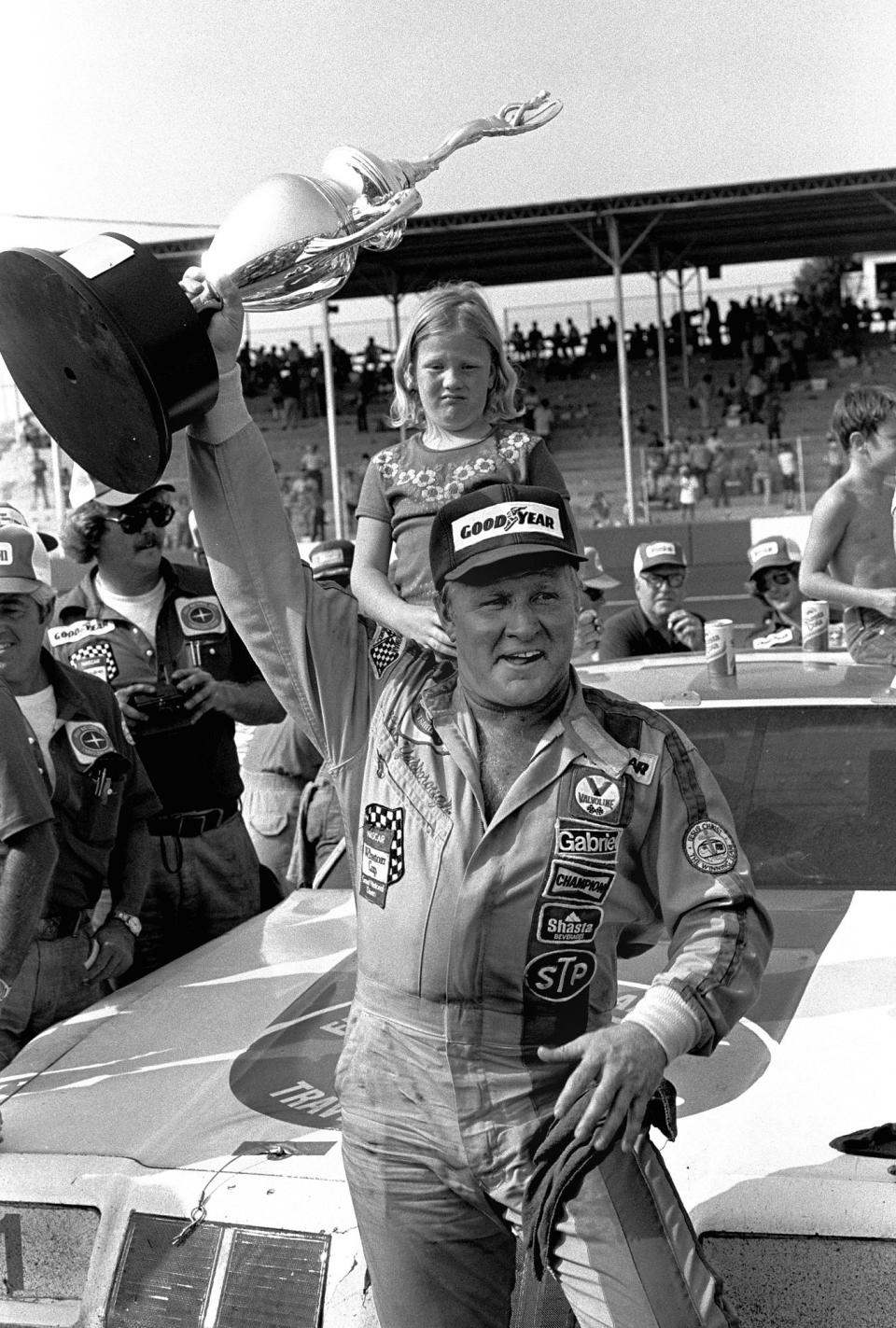 FILE - Cale Yarborough of Timmonsville S.C., holds his trophy high in the air in Victory Lane after winning the Southern 500 stock race at Darlington Raceway, in Darlington, S.C., Sept. 4, 1978. Darlington Raceway will pay tribute to the late NASCAR Hall of Famer Cale Yarborough by displaying his No. 29 1988 Oldsmobile Cutlass during its throwback weekend at the Goodyear 400 in May. (AP Photo)