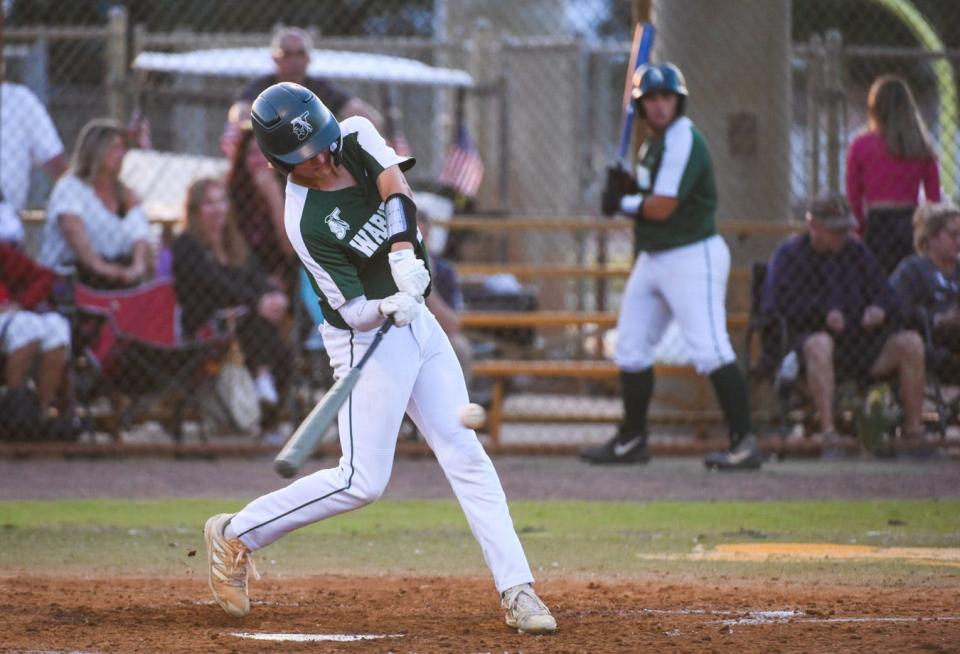 Jupiter's Andrew Todd (28) hits a single, scoring a teammate at the bottom of the fourth inning during the varsity baseball game between host Jupiter and Dwyer in Jupiter, FL., on Monday, March 28, 2022. Final score, Jupiter, 3, Dwyer, 1.