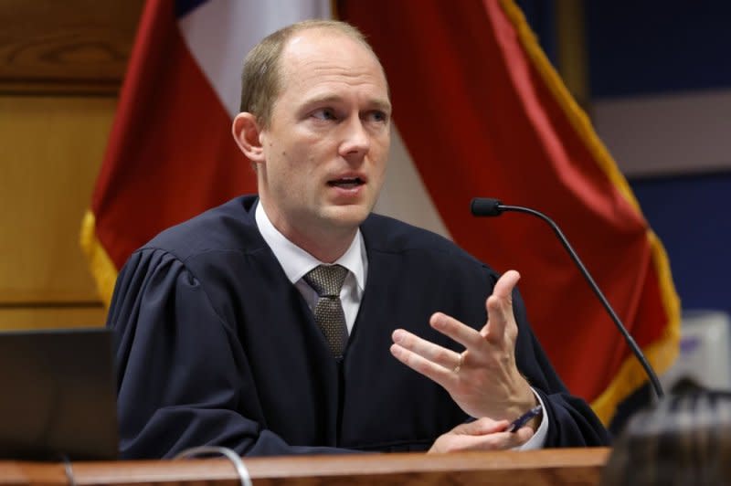 Fulton County Superior Judge Scott McAfee presides over a hearing on the Georgia election interference case in Atlanta on March 1. District Attorney Fani Willis initially sought to try former President Donald Trump and 19 co-defendants last fall but a trial date has not been set. Pool Photo by Alex Slitz/EPA-EFE