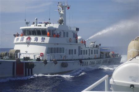 A Chinese ship (L) uses water cannon on a Vietnamese Sea Guard ship on the South China Sea near the Paracels islands, in this handout photo taken on May 2, 2014 and released by the Vietnamese Marine Guard on May 8, 2014. REUTERS/Vietnam Marine Guard/Handout via Reuters