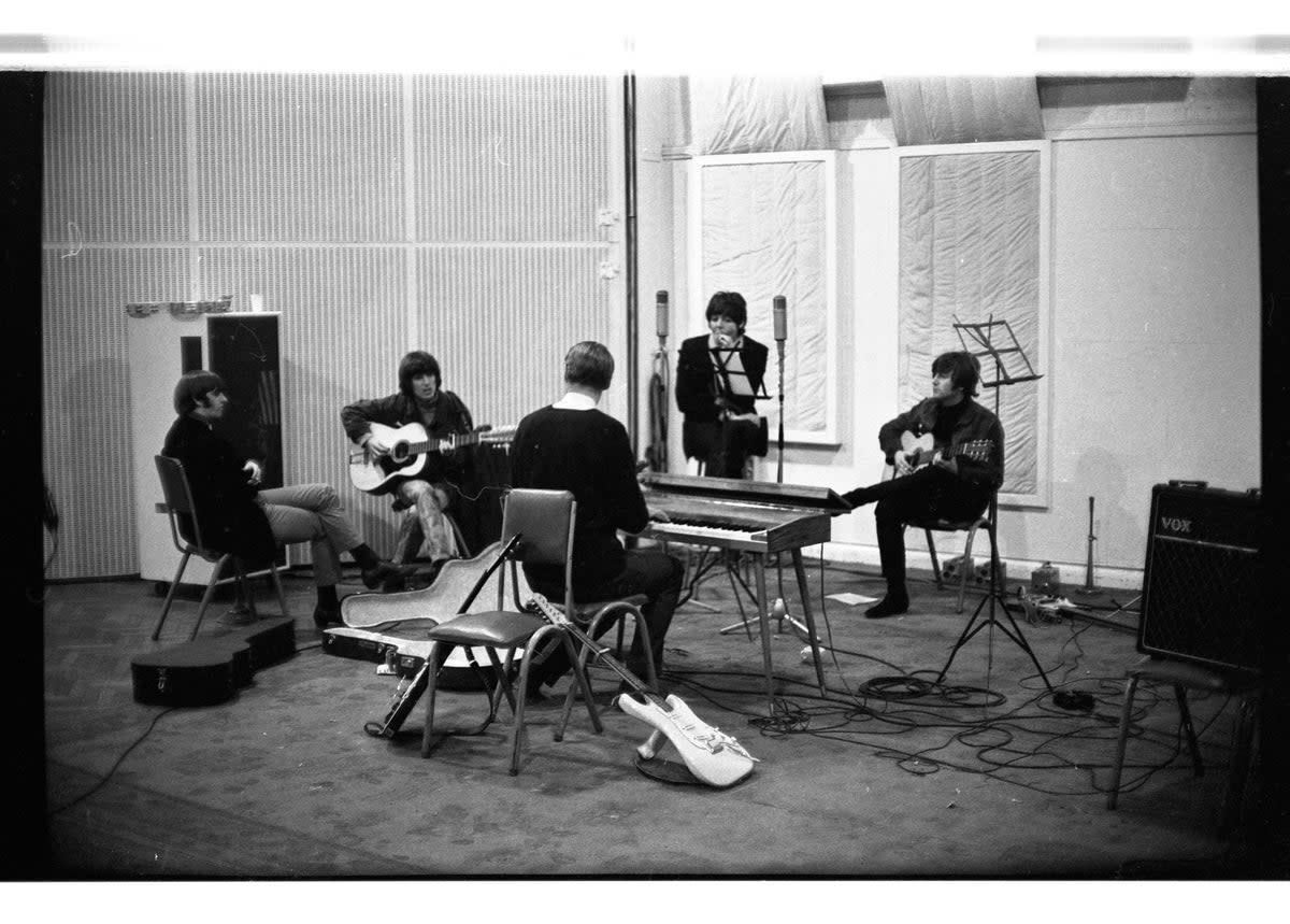 George Harrison playing the guitar during a Beatles studio session (Beatles Book Photo Library)