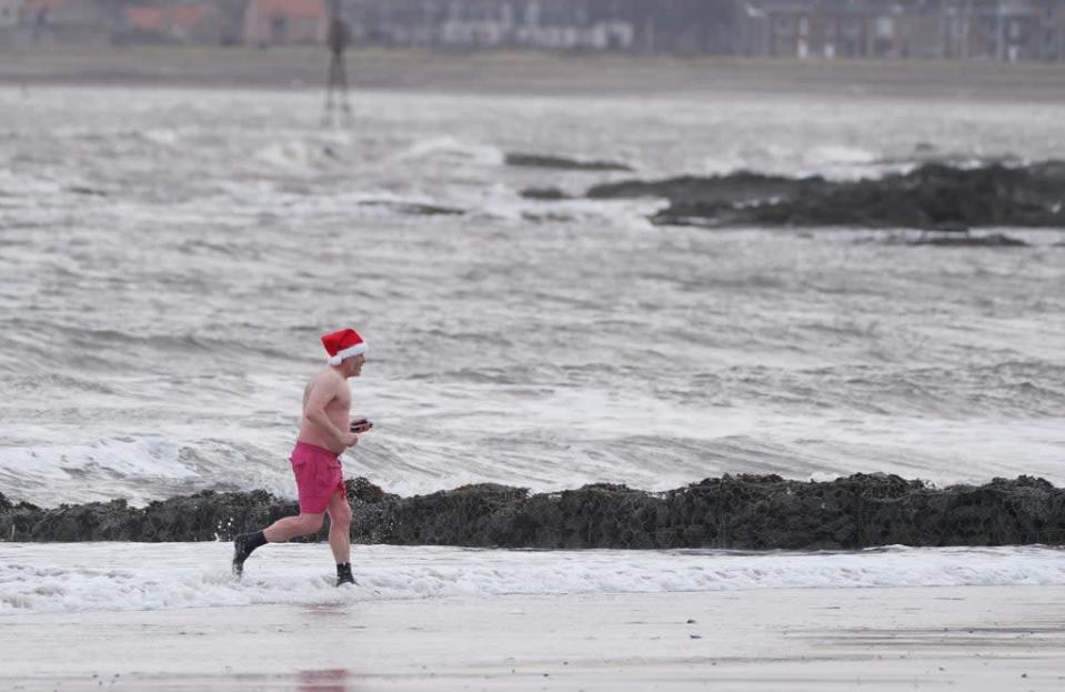 Santa ditched some of his costume for a Christmas Day dip (Andrew Milligan/PA) (PA Wire)