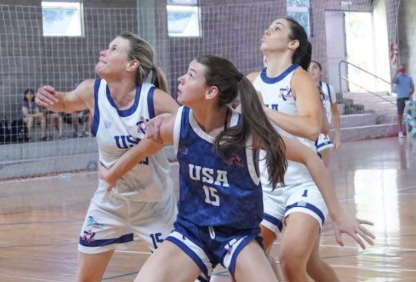 Carolyn Dorfman of Mamaroneck and her daughter Addison, 15, playing against each other in basketball at the Maccabi Pan-Am Games in Argentina in December. Carolyn played on the USA open team, and Addison played on the USA U18 team. When countries pulled out over security concerns, Addison's team was forced to play against adult teams, including playing against her mother.