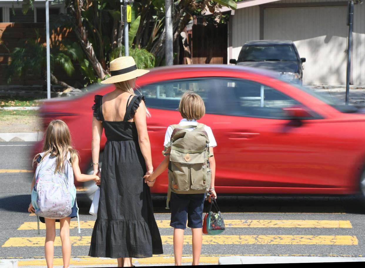 A car fails to yield as a family attempts to cross a road in Long Beach, Calif. <a href="https://www.gettyimages.com/detail/news-photo/car-fails-to-yield-as-a-family-attempts-to-cross-the-street-news-photo/1339526318" rel="nofollow noopener" target="_blank" data-ylk="slk:Brittany Murray/MediaNews Group/Long Beach Press-Telegram via Getty Images;elm:context_link;itc:0;sec:content-canvas" class="link ">Brittany Murray/MediaNews Group/Long Beach Press-Telegram via Getty Images</a>