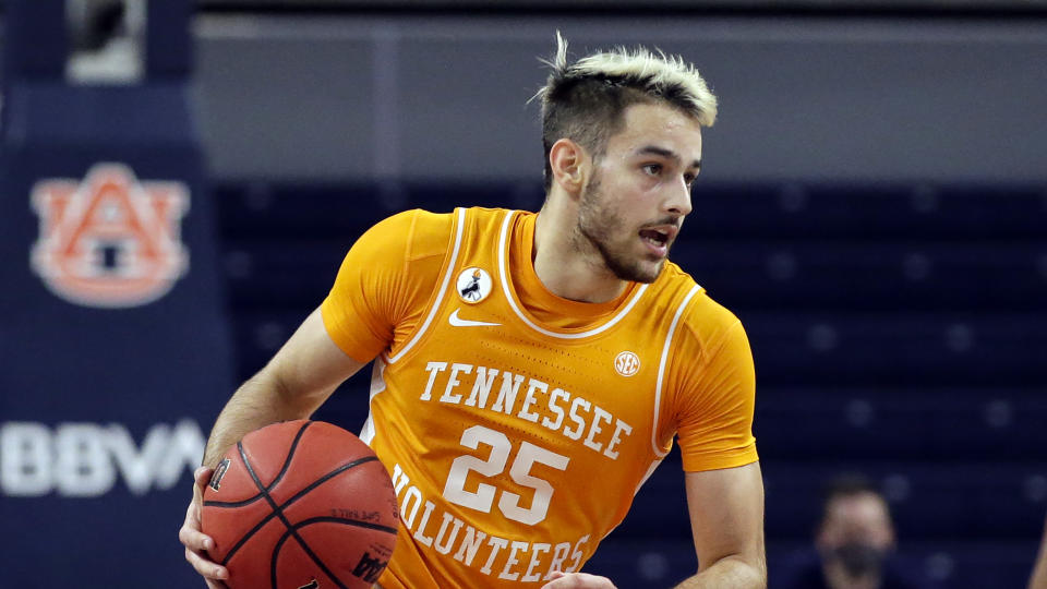 FILE - In this file photo dated Saturday, Feb. 27, 2021, Tennessee guard Santiago Vescovi brings the ball downcourt against Auburn during the second half of an NCAA basketball game, in Auburn, USA. The NBA's global academy system is beginning to produce high-level collegiate players, as the upcoming NCAA Tournament will include eight NBA Academy alumni. (AP Photo/Butch Dill, FILE)