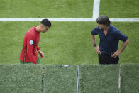 Germany's manager Joachim Loew, right, looks to Portugal's Cristiano Ronaldo during the Euro 2020 soccer championship group F match between Portugal and Germany at the football arena stadium in Munich, Saturday, June 19, 2021. (Matthias Hangst/Pool Photo via AP)