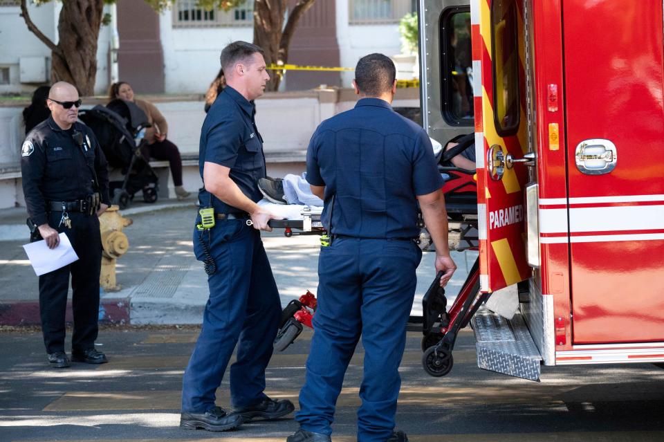A victim from a brawl and stabbing Wednesday at Van Nuys High School is taken to a waiting ambulance outside of the school near Los Angeles. Eleven students total were involved in a brawl, which left three students hospitalized, two of whom had been stabbed.