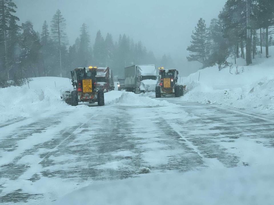 Bulldozers work to clear snow on Interstate 80 near Donner Pass on Saturday, March 2, 2024, after authorities shut down the major freeway due to spinout conditions. A blizzard that was raking over the Sierra is expected to dump as much as 12 feet of snow on the region by the end of Sunday.